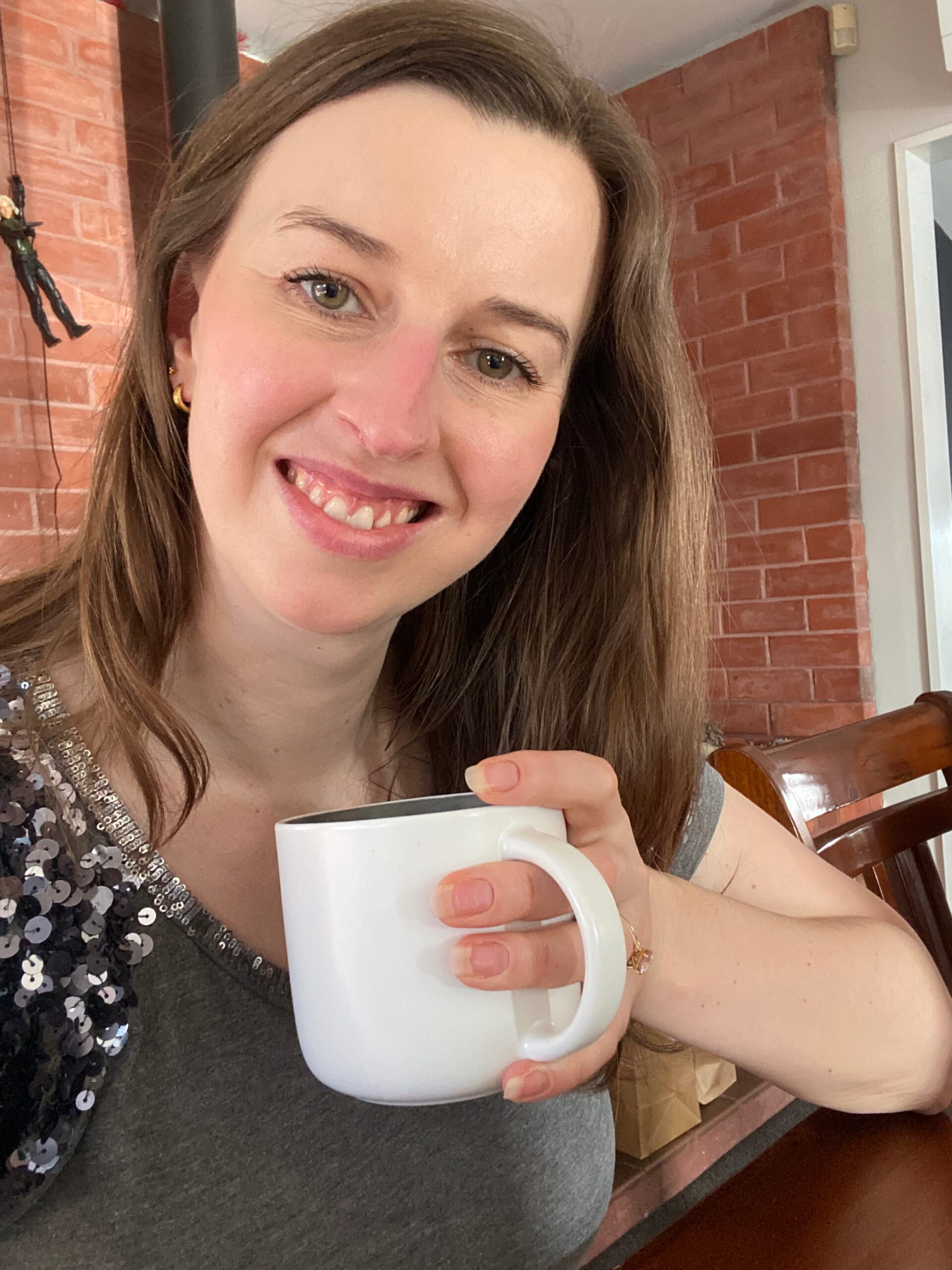 Woman drinking from white mug
